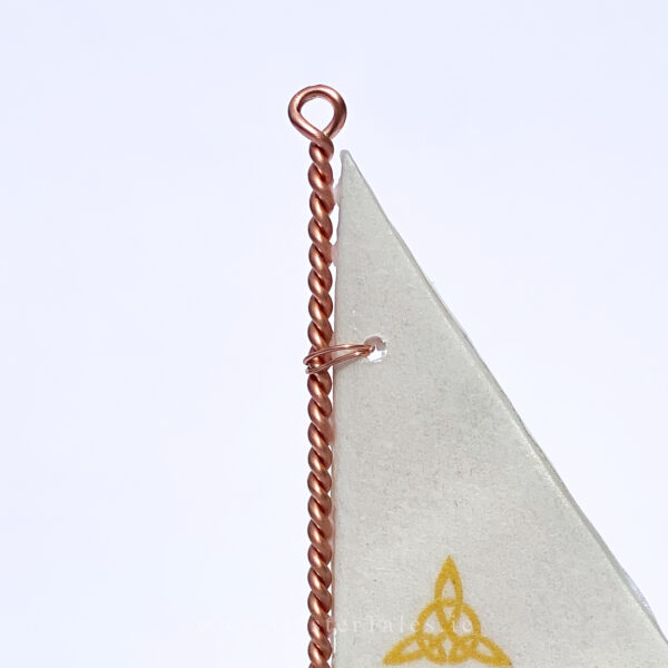 Close up of Irish made Oyster shell ornament. Copper wire work detail.